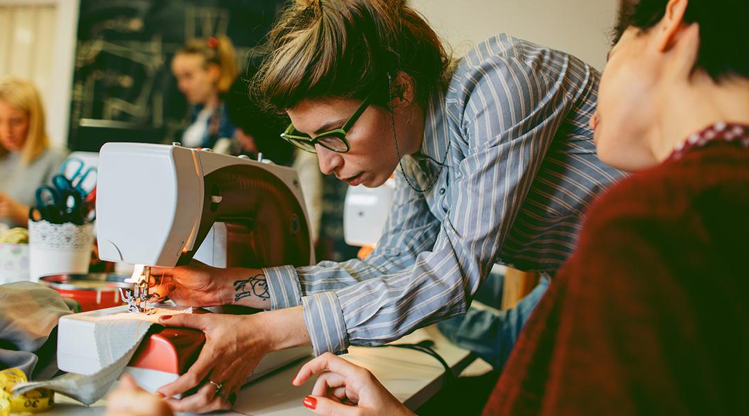 adults sewing at a machine